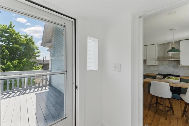 doorway to outside with hardwood / wood-style floors and plenty of natural light