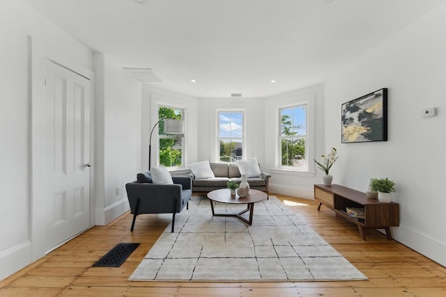 sitting room with healthy amount of natural light, baseboards, hardwood / wood-style flooring, and recessed lighting