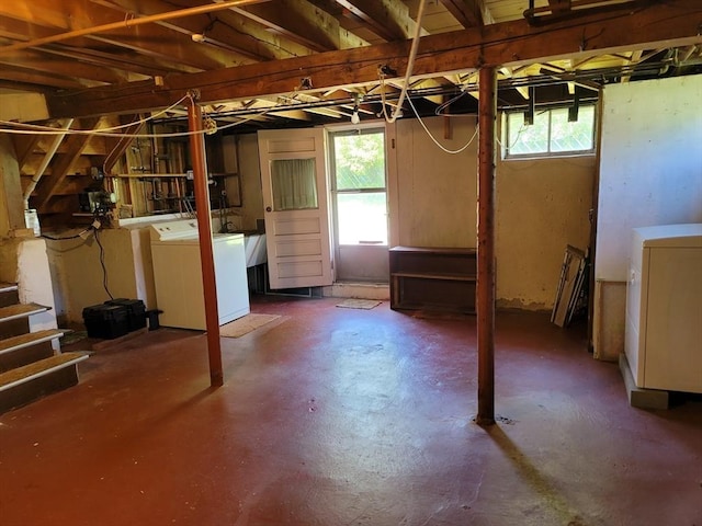 below grade area with separate washer and dryer and a sink