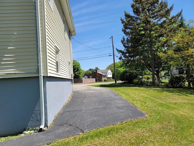 view of property exterior with a lawn