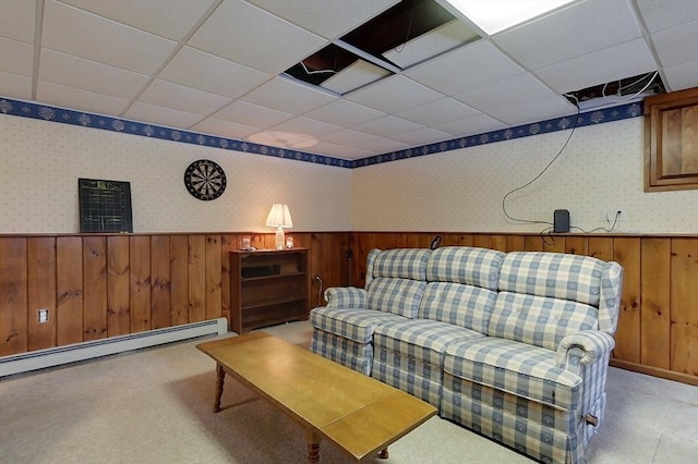 living area featuring a wainscoted wall, wallpapered walls, a paneled ceiling, light carpet, and baseboard heating