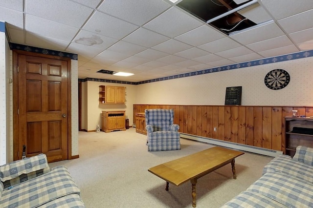 living room with wallpapered walls, a wainscoted wall, light colored carpet, a paneled ceiling, and a baseboard radiator