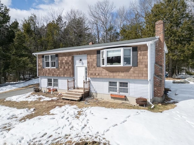 split foyer home featuring a chimney