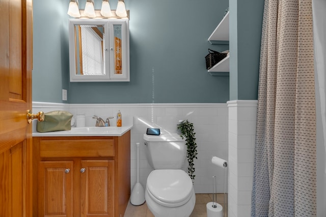 bathroom with tile patterned flooring, toilet, tile walls, and curtained shower