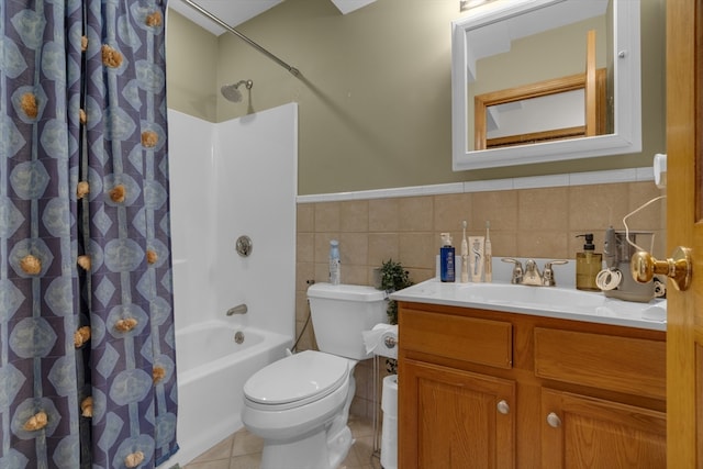 full bathroom with vanity, shower / bathtub combination with curtain, tile walls, tile patterned flooring, and toilet