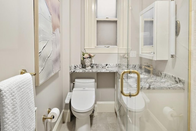 bathroom with tile patterned floors, sink, an enclosed shower, and toilet