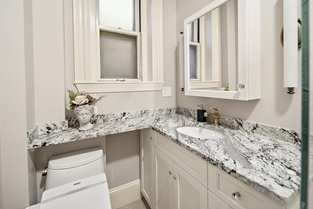 bathroom featuring vanity and toilet