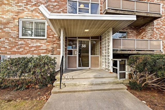 view of exterior entry featuring a balcony