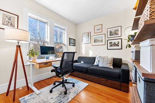 home office with light wood finished floors and baseboards