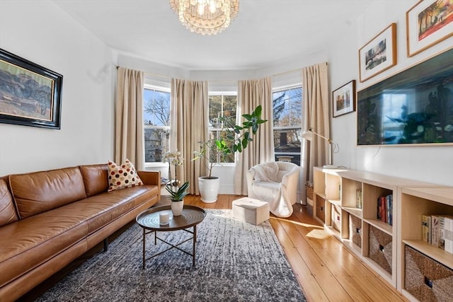 living area featuring wood finished floors and a notable chandelier