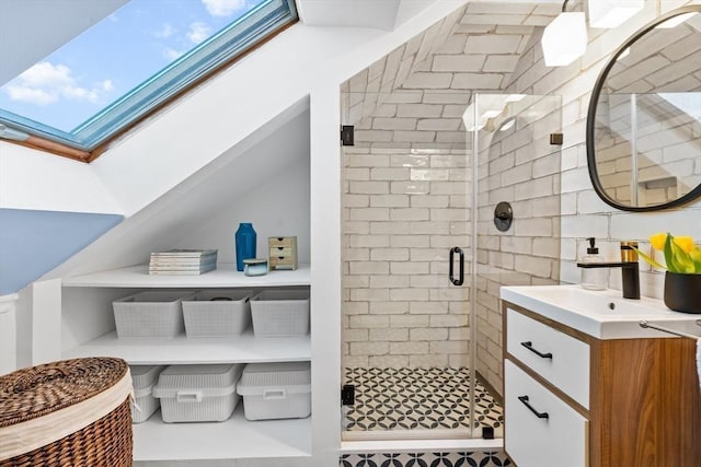 bathroom featuring lofted ceiling with skylight, a shower stall, vanity, and backsplash