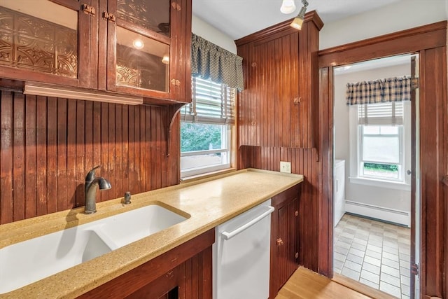 259 Main St, Blackstone, MA 01504 - kitchen featuring dishwasher, a sink, a baseboard radiator, glass insert cabinets, and light stone countertops