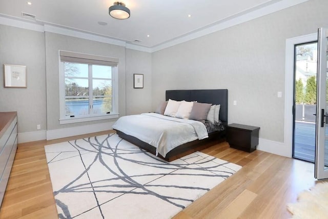 bedroom featuring access to exterior, light hardwood / wood-style flooring, and ornamental molding