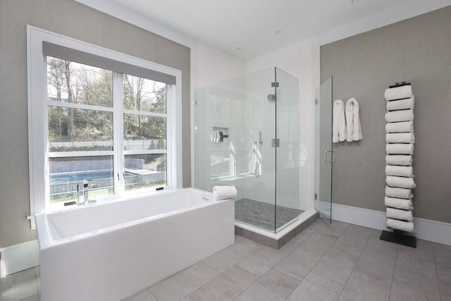 bathroom with tile patterned floors and independent shower and bath