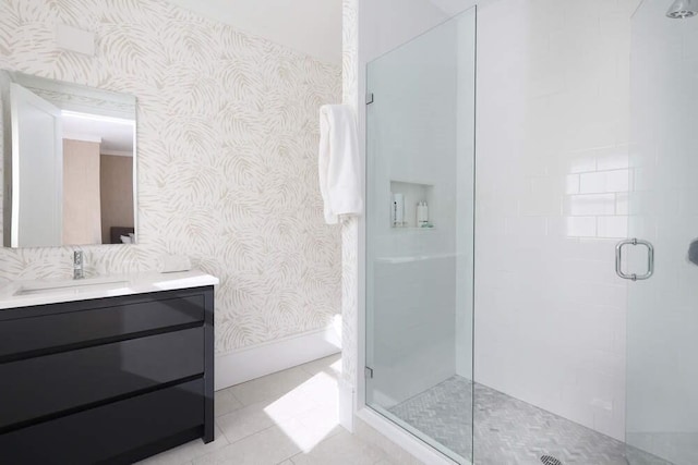 bathroom with tile patterned flooring, vanity, and a shower with door