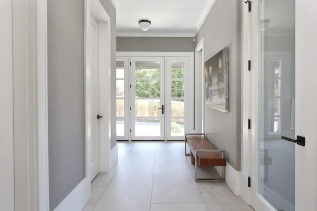 doorway featuring ornamental molding and light tile patterned flooring