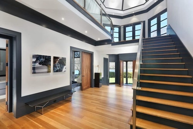 entrance foyer with a high ceiling and hardwood / wood-style floors