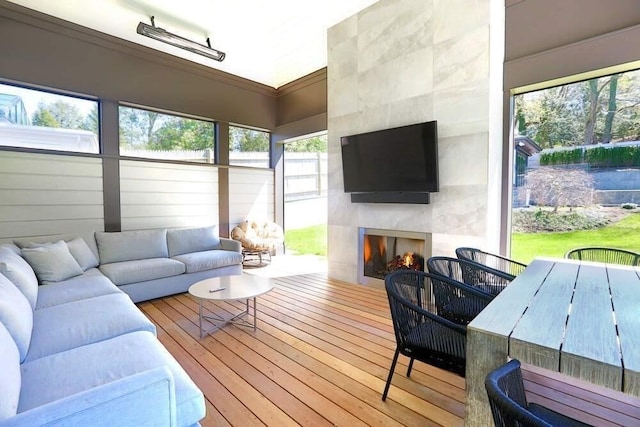 sunroom / solarium with a tiled fireplace