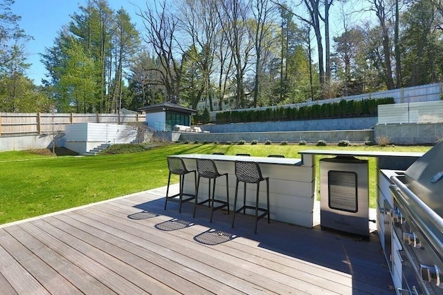 wooden terrace with a yard and exterior bar