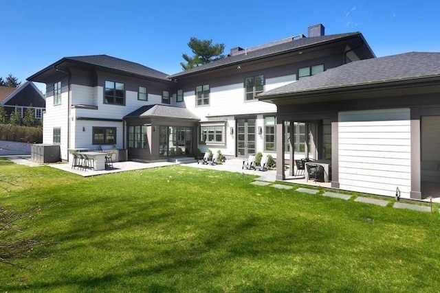 rear view of house with a patio area and a yard