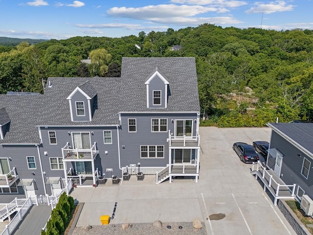 47 Parker St Unit 3, Quincy, MA 02169 - rear view of property featuring a view of trees, a patio, a balcony, and a shingled roof