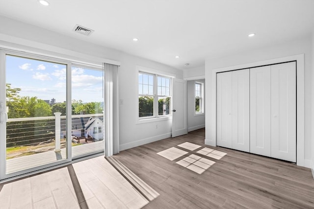 47 Parker St Unit 3, Quincy, MA 02169 - unfurnished bedroom with access to exterior, wood finished floors, recessed lighting, and a closet