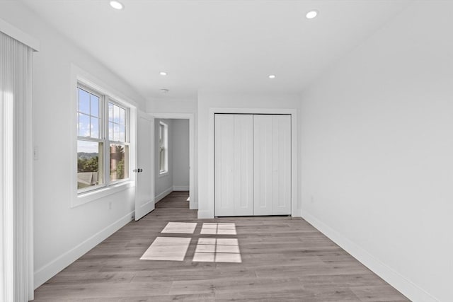 47 Parker St Unit 3, Quincy, MA 02169 - unfurnished bedroom with recessed lighting, light wood finished floors, and a closet