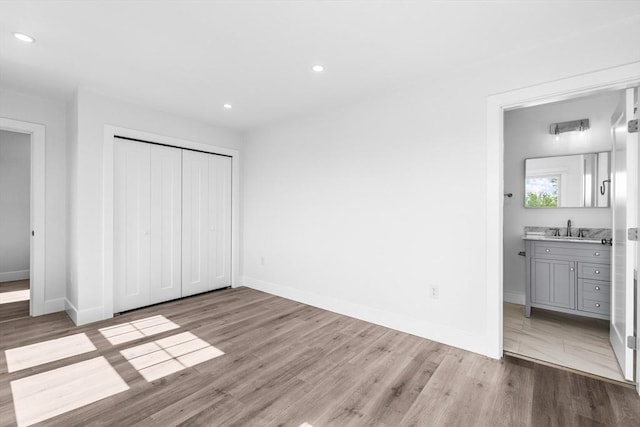 47 Parker St Unit 3, Quincy, MA 02169 - unfurnished bedroom featuring wood finished floors, a closet, recessed lighting, and ensuite bathroom