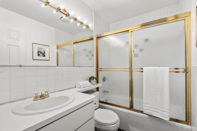 3 Melrose St Unit 3, Boston, MA 02116 - bathroom with vanity, tasteful backsplash, bath / shower combo with glass door, toilet, and tile walls