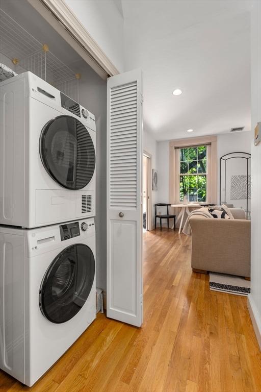 3 Melrose St Unit 3, Boston, MA 02116 - laundry room with estacked washer and dryer, light wood finished floors, and recessed lighting