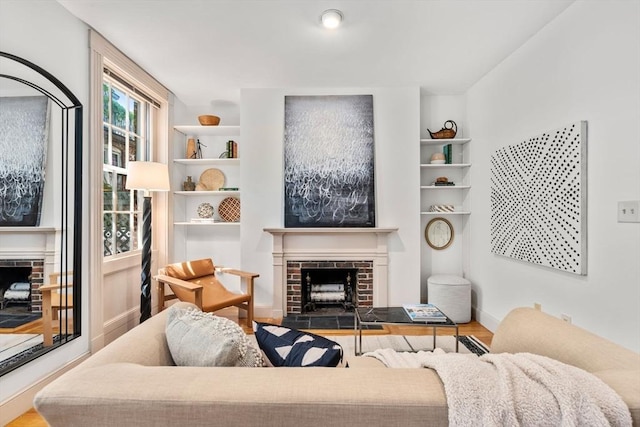 3 Melrose St Unit 3, Boston, MA 02116 - living area featuring a brick fireplace, wood finished floors, and baseboards