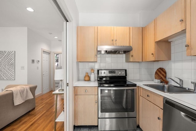 3 Melrose St Unit 3, Boston, MA 02116 - kitchen with stainless steel appliances, under cabinet range hood, a sink, light countertops, and recessed lighting