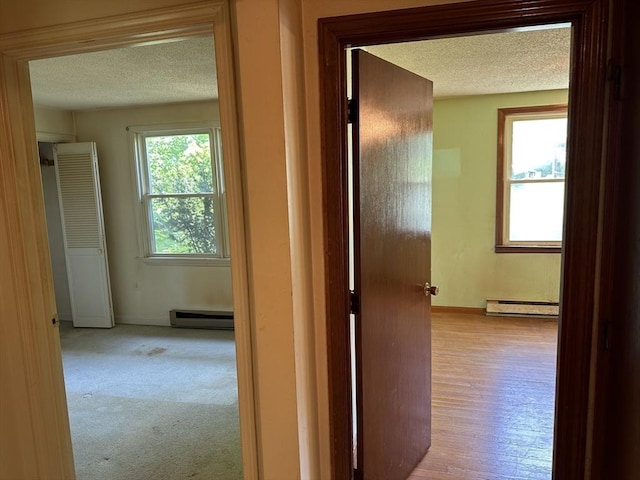 11 Glenwood St, Whitman, MA 02382 - corridor with a textured ceiling, a baseboard heating unit, a baseboard radiator, and carpet