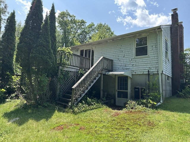 11 Glenwood St, Whitman, MA 02382 - rear view of house with a chimney, stairway, a wooden deck, and a yard