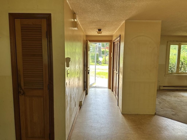 11 Glenwood St, Whitman, MA 02382 - corridor featuring a textured ceiling and a baseboard radiator