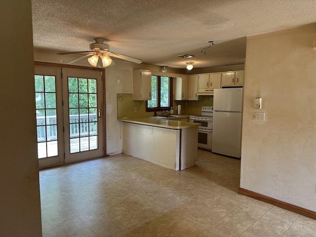 11 Glenwood St, Whitman, MA 02382 - kitchen featuring freestanding refrigerator, double oven range, under cabinet range hood, a peninsula, and a textured ceiling
