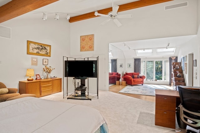 bedroom with track lighting, high vaulted ceiling, beamed ceiling, and ceiling fan