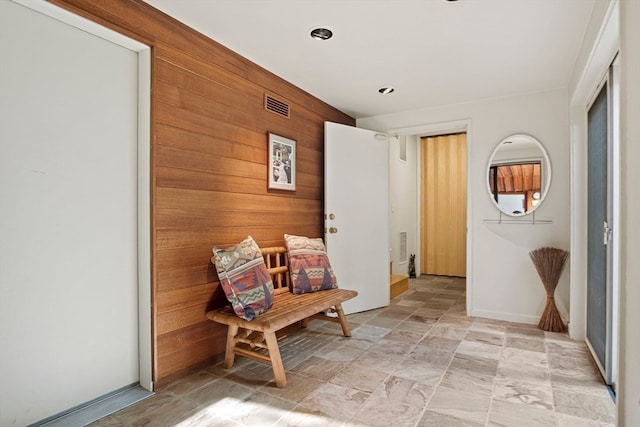 living area featuring wooden walls