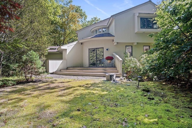 view of front of house featuring a front yard and a wooden deck