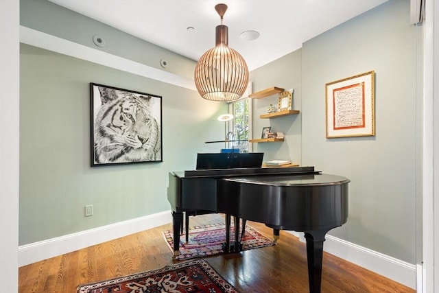 living area with wood finished floors and baseboards