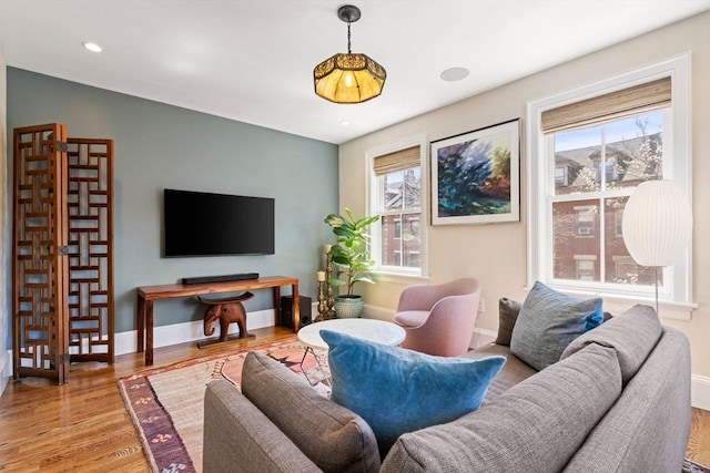 living area with wood finished floors, baseboards, and recessed lighting
