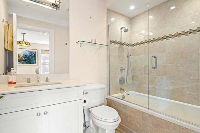 bathroom with tiled shower / bath combo, toilet, vanity, and recessed lighting