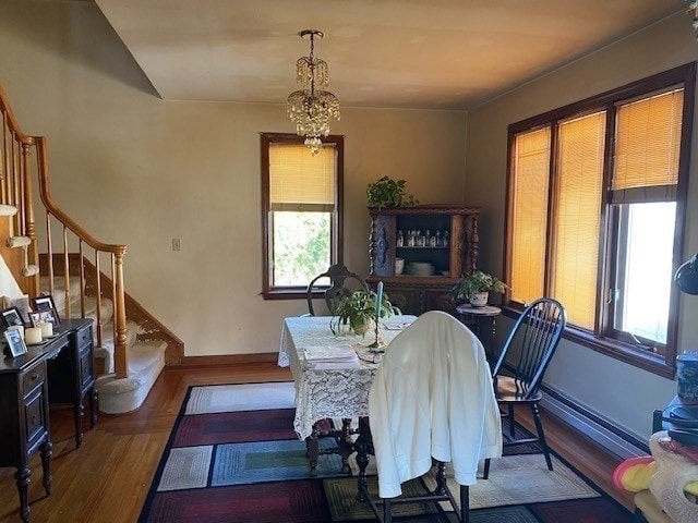 dining room with a notable chandelier and dark hardwood / wood-style floors