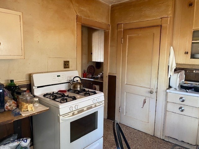 kitchen with white range with gas stovetop