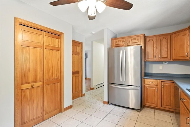 315 Woodland Way, Russell, MA 01071 - kitchen with stainless steel appliances, a baseboard radiator, a ceiling fan, brown cabinets, and dark countertops