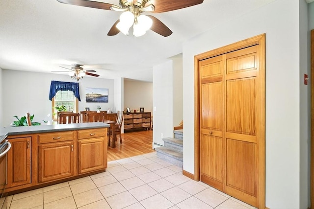 315 Woodland Way, Russell, MA 01071 - kitchen with a ceiling fan, light tile patterned flooring, brown cabinetry, and dishwashing machine