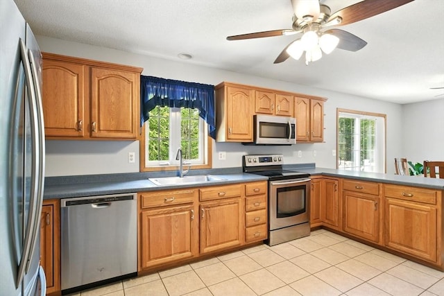 315 Woodland Way, Russell, MA 01071 - kitchen featuring appliances with stainless steel finishes, a sink, brown cabinetry, dark countertops, and ceiling fan