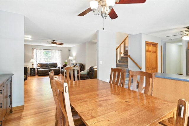 315 Woodland Way, Russell, MA 01071 - dining room featuring ceiling fan, light wood-style floors, and stairs