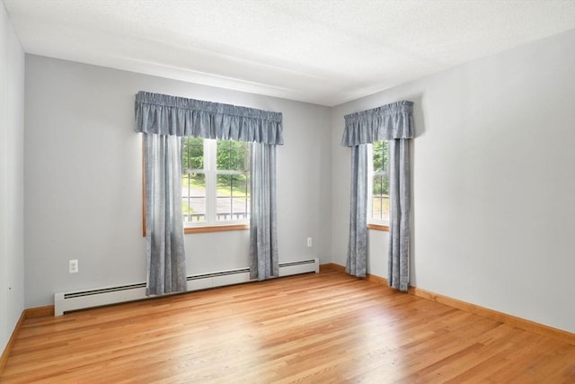 315 Woodland Way, Russell, MA 01071 - spare room with light wood-style floors, baseboards, a baseboard heating unit, and a textured ceiling
