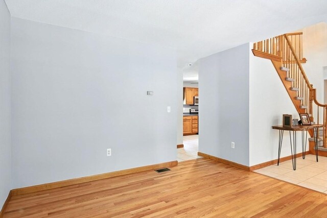 315 Woodland Way, Russell, MA 01071 - unfurnished room with light wood-style floors, stairway, and baseboards